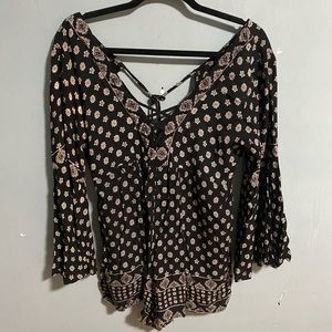 A black and white designed romper